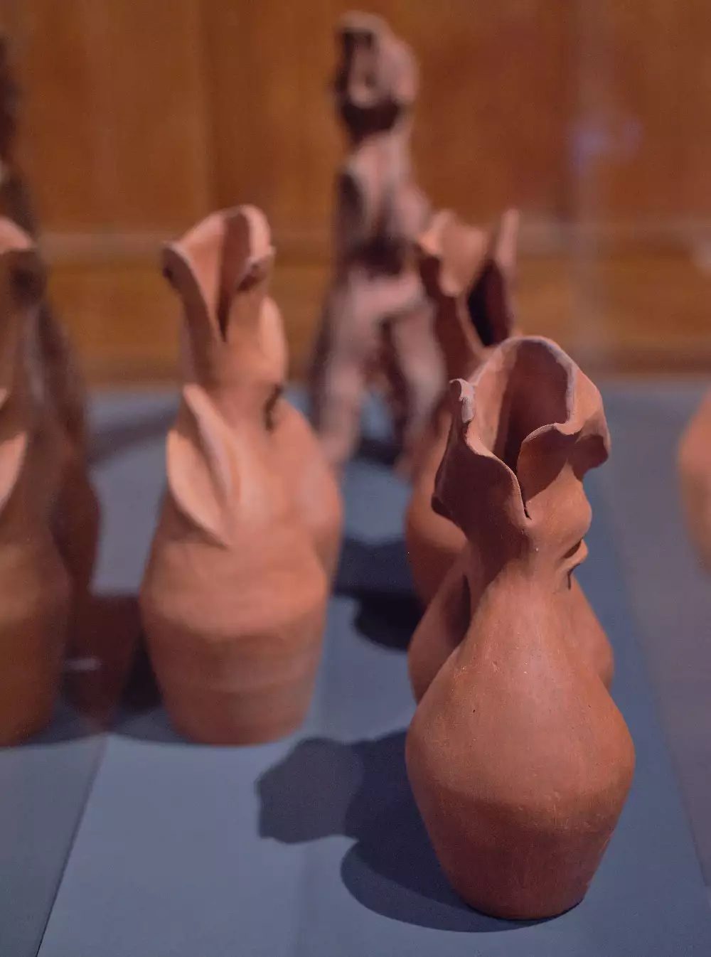 Bisila Noha, Reunion I, II & III, 2021, Terracotta, On loan from the artist. Exhibition view: Body Vessel Clay: Black Women, Ceramics & Contemporary Art, Two Temple Place, London (29 January–24 April 2022). © Two Temple Place. Courtesy Two Temple Place. Photo: Amit Lennon Image shows four terracotta clay pots ontop if a grey plinth
