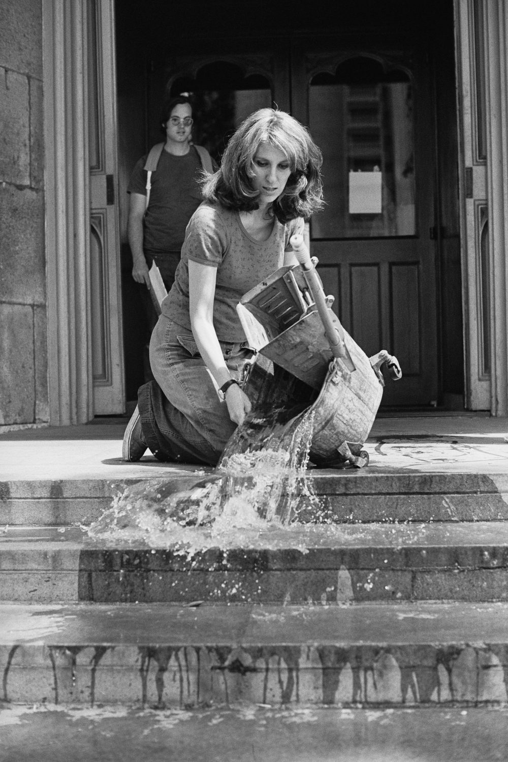 Mierle Laderman Ukeles washing the steps of the Guggenheim Museum in New York, 1969.